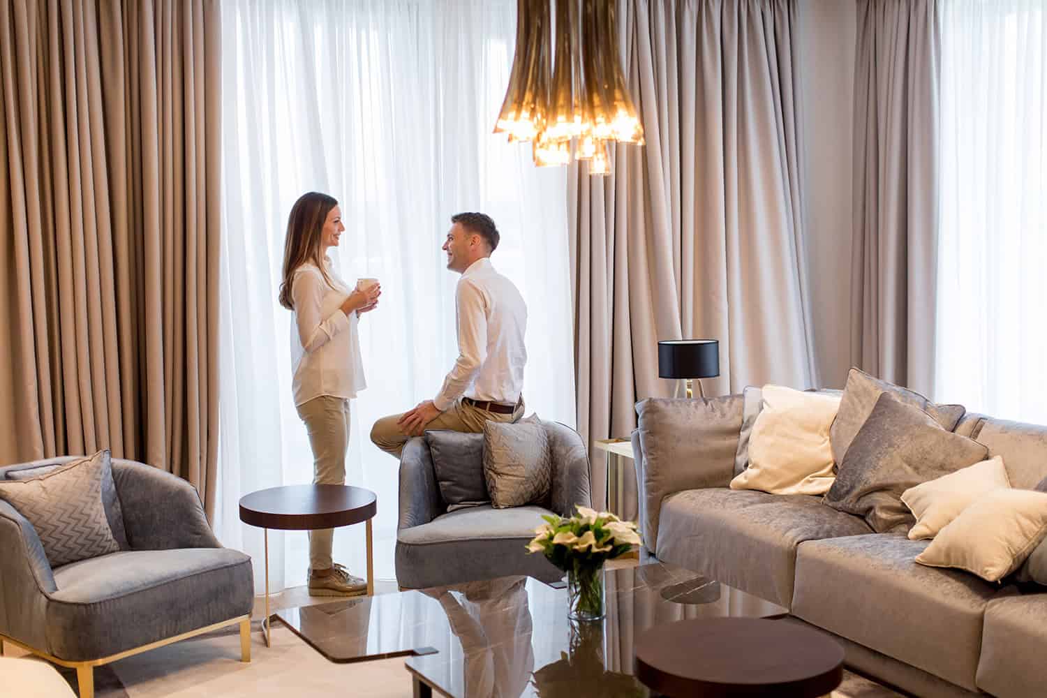 Woman and a man speaking in the living room.